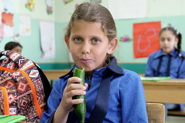 Girl eating cucumber, Jordan
