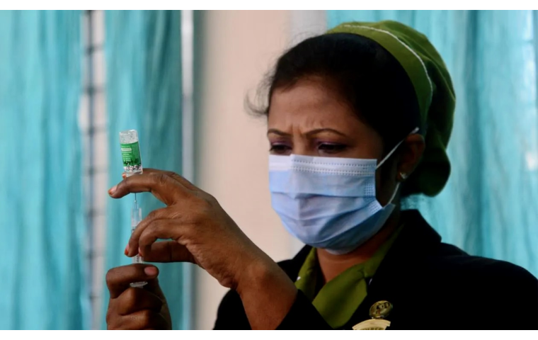 Woman health worker in Bangladesh fills a syringe