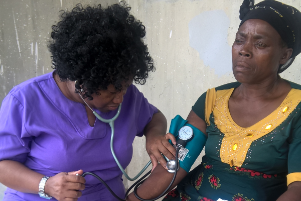 A health worker checks a patient's blood pressure  at a clinic in Umueleagwa Onicha, Ezinihitte Mbaise Local Government Area, Nigeria, 2017