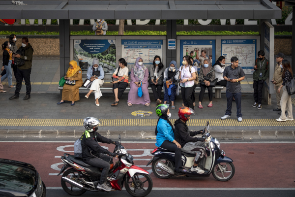 Commuters wait for public transportation in Jakarta, Indonesia on November 7, 2023.