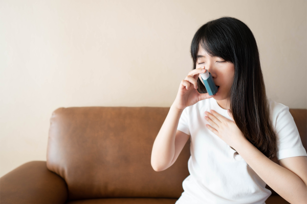 Woman using an inhaler