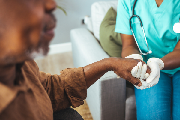 Male patient receiving support from medical professional