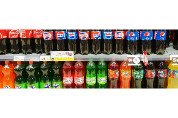 Closeup of Stacked Pepsi bottle and soda soft drink in supermarket.